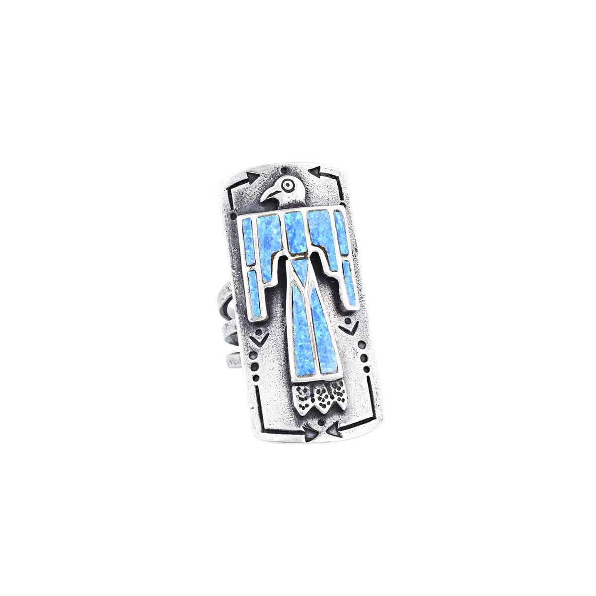 A sterling silver shield ring with blue opal stones inlayed into an intricate thunderbird design. Added stamping and the split shank design of the band make this ring exceptional. 