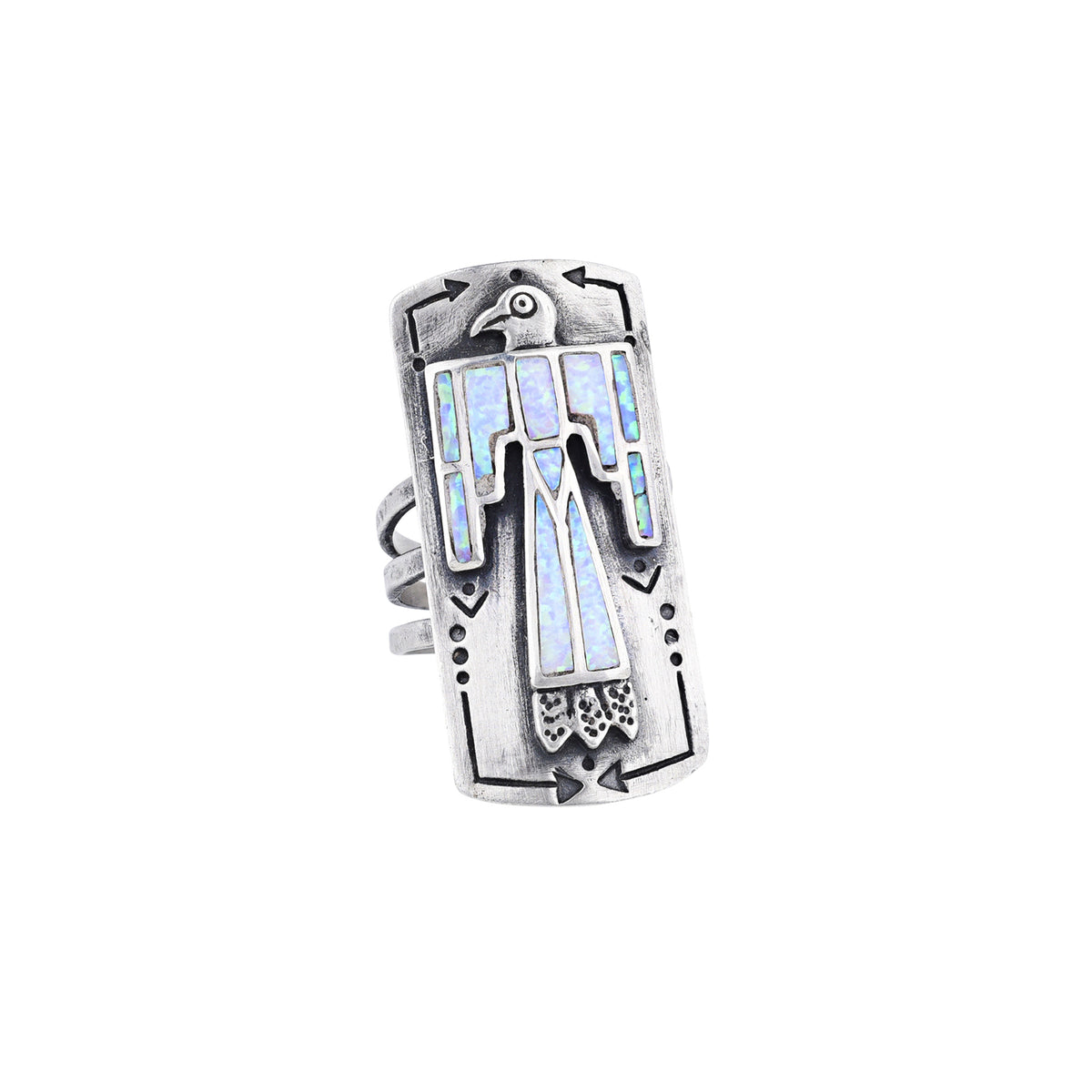 A sterling silver shield ring with white opal stones inlayed into an intricate thunderbird design. Added stamping and the split shank design of the band make this ring exceptional. 