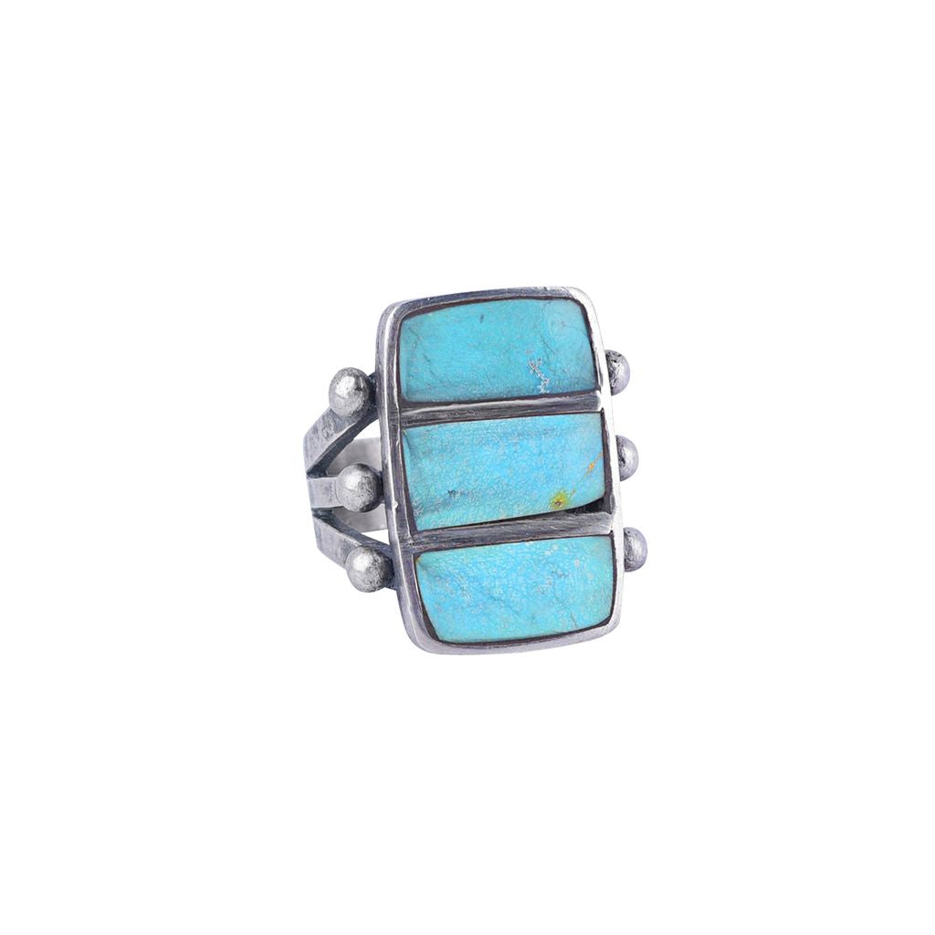A sterling silver ring featuring three stacked rectangular blue turquoise stones, accented with small silver beads on the sides, with a split shank band.