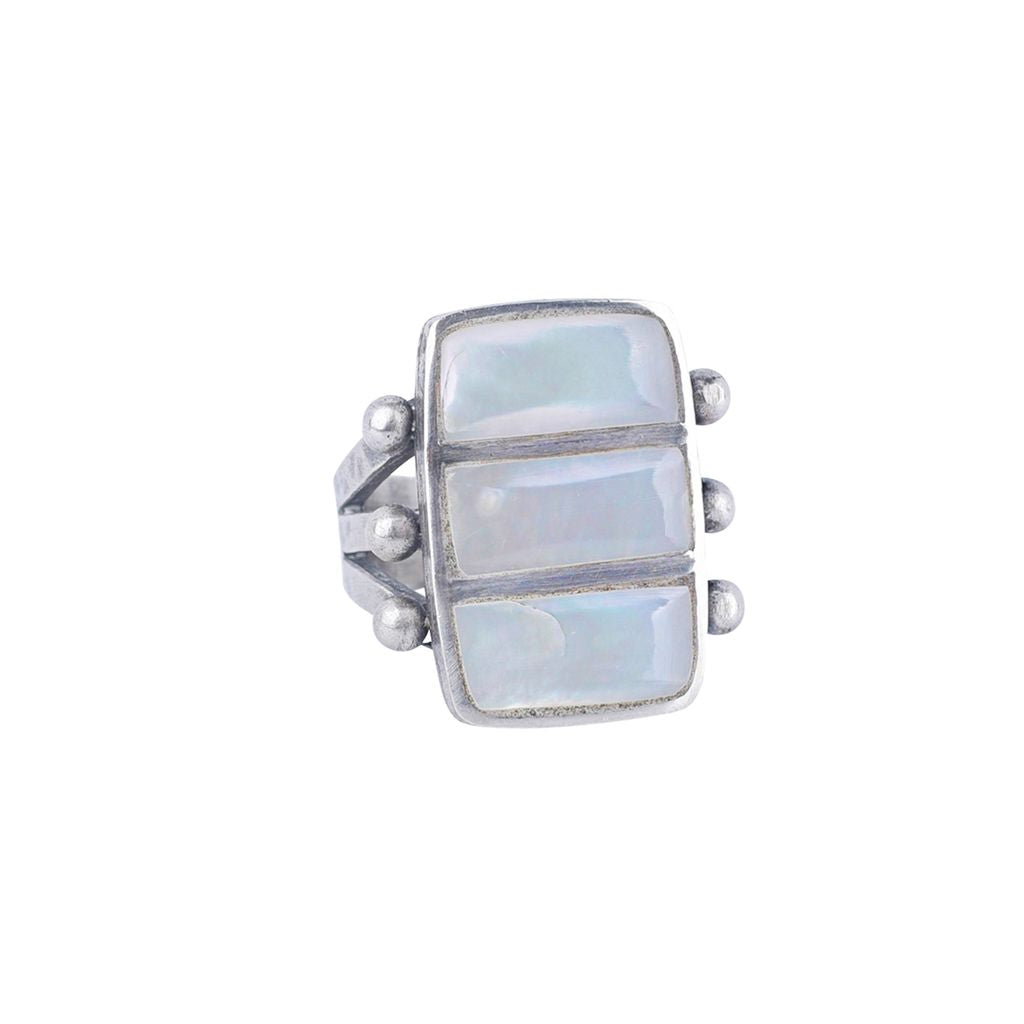 A sterling silver ring featuring three stacked rectangular mother of pearl stones, accented with small silver beads on the sides, with a split shank band.