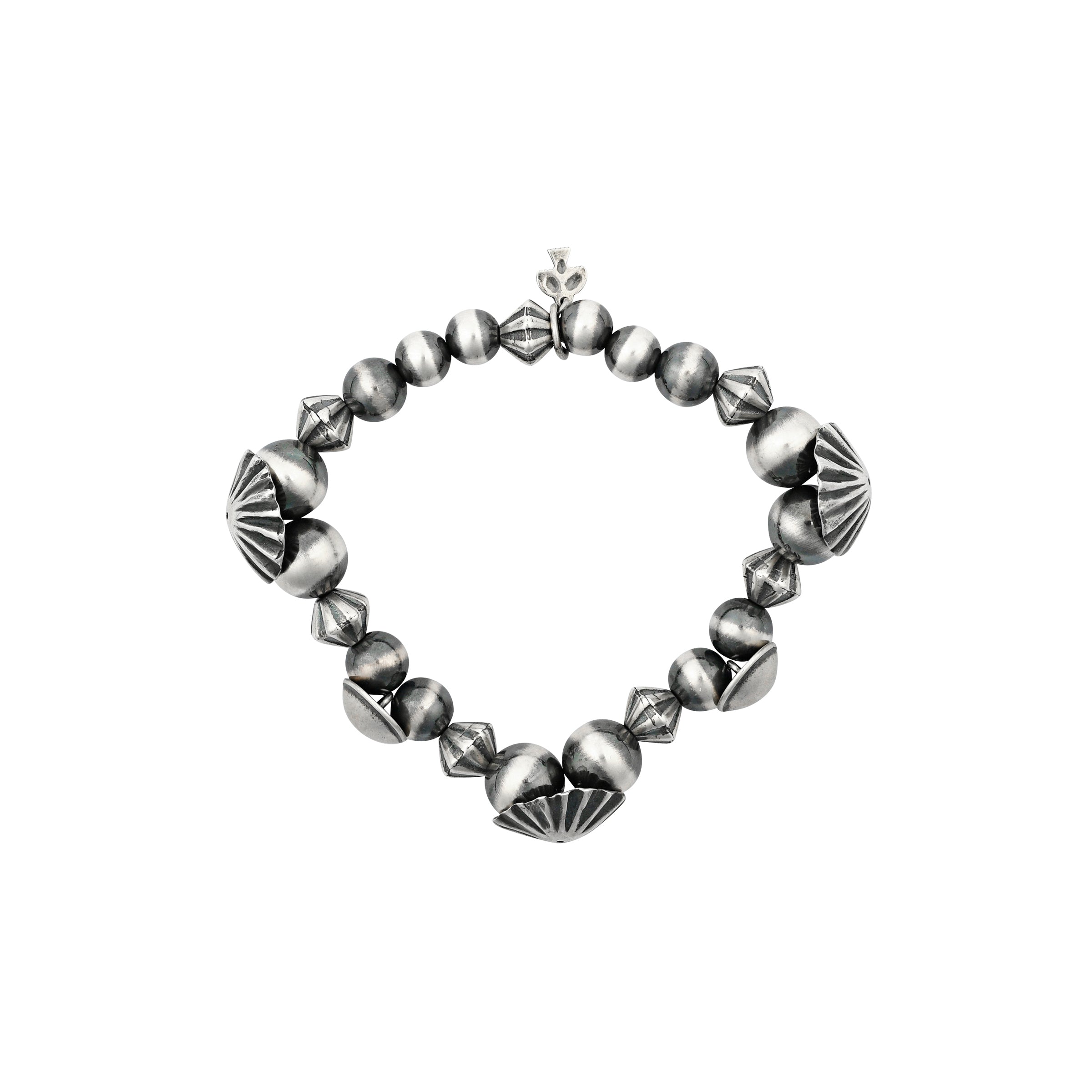 A stretch bracelet strung with vintage inspired beading, desert pearls, and classic Southwestern conchos.