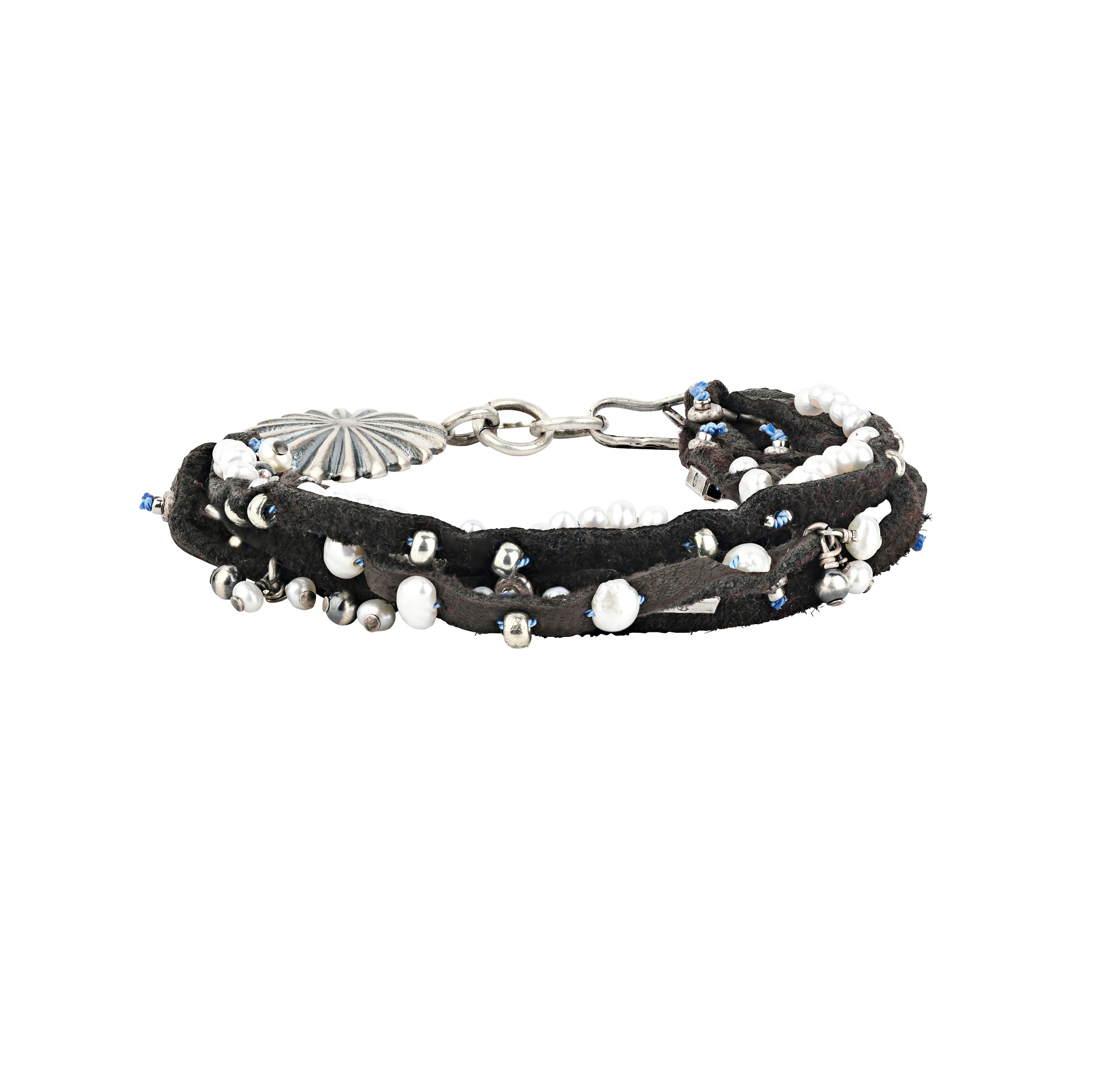 A multi-strand leather bracelet featuring charms of Freshwater Pearl and Sterling Silver beading. Topped with a Southwestern style concho and hook toggle for a stylish fit.