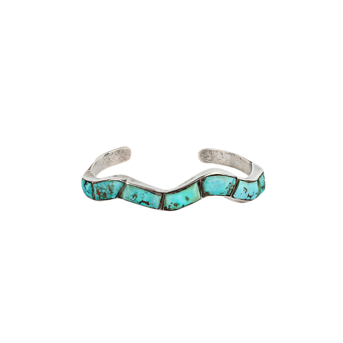 A vintage wavy patterned bracelet cuff made with Morenci Turquoise in Sterling Silver. 
