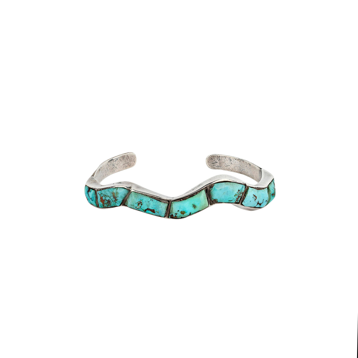 A vintage wavy patterned bracelet cuff made with Morenci Turquoise in Sterling Silver. 