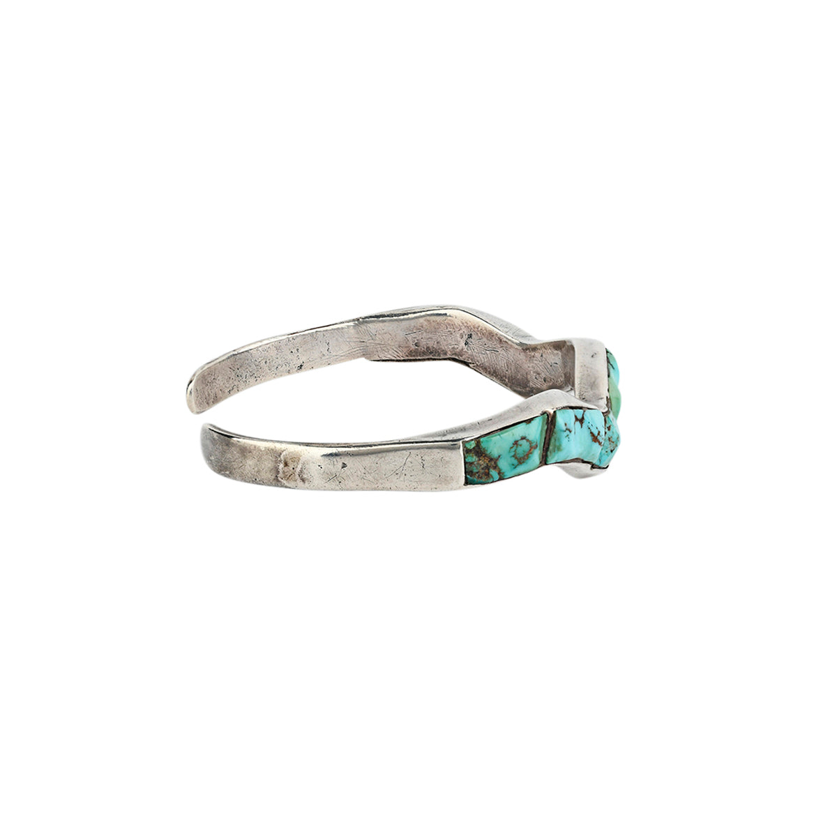 A vintage wavy patterned bracelet cuff made with Morenci Turquoise in Sterling Silver. 
