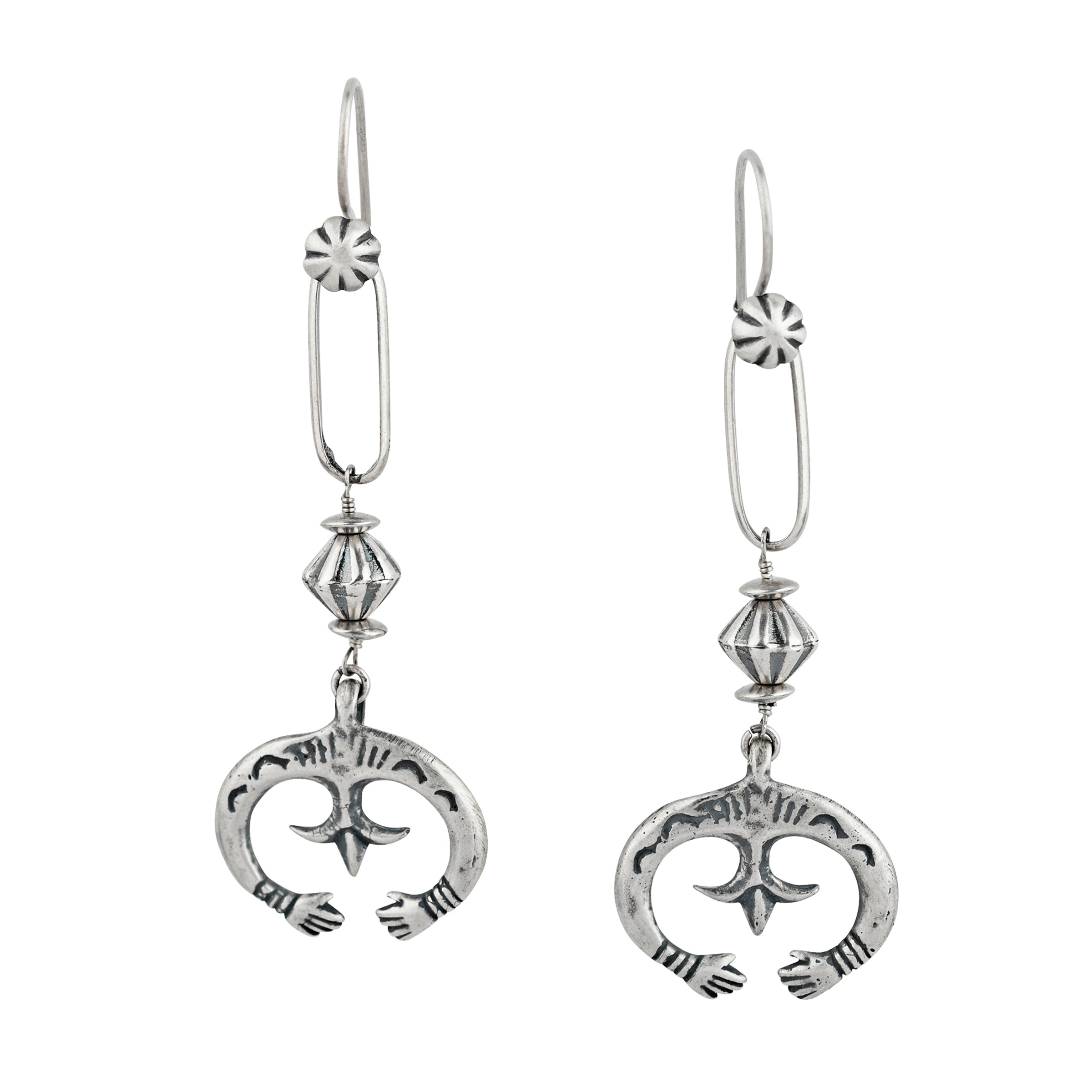 Dangle, drop earrings featuring charms of hands reaching around a fleur-cross and topped with corrugated beading and chain loops on a concho studded earwire.
