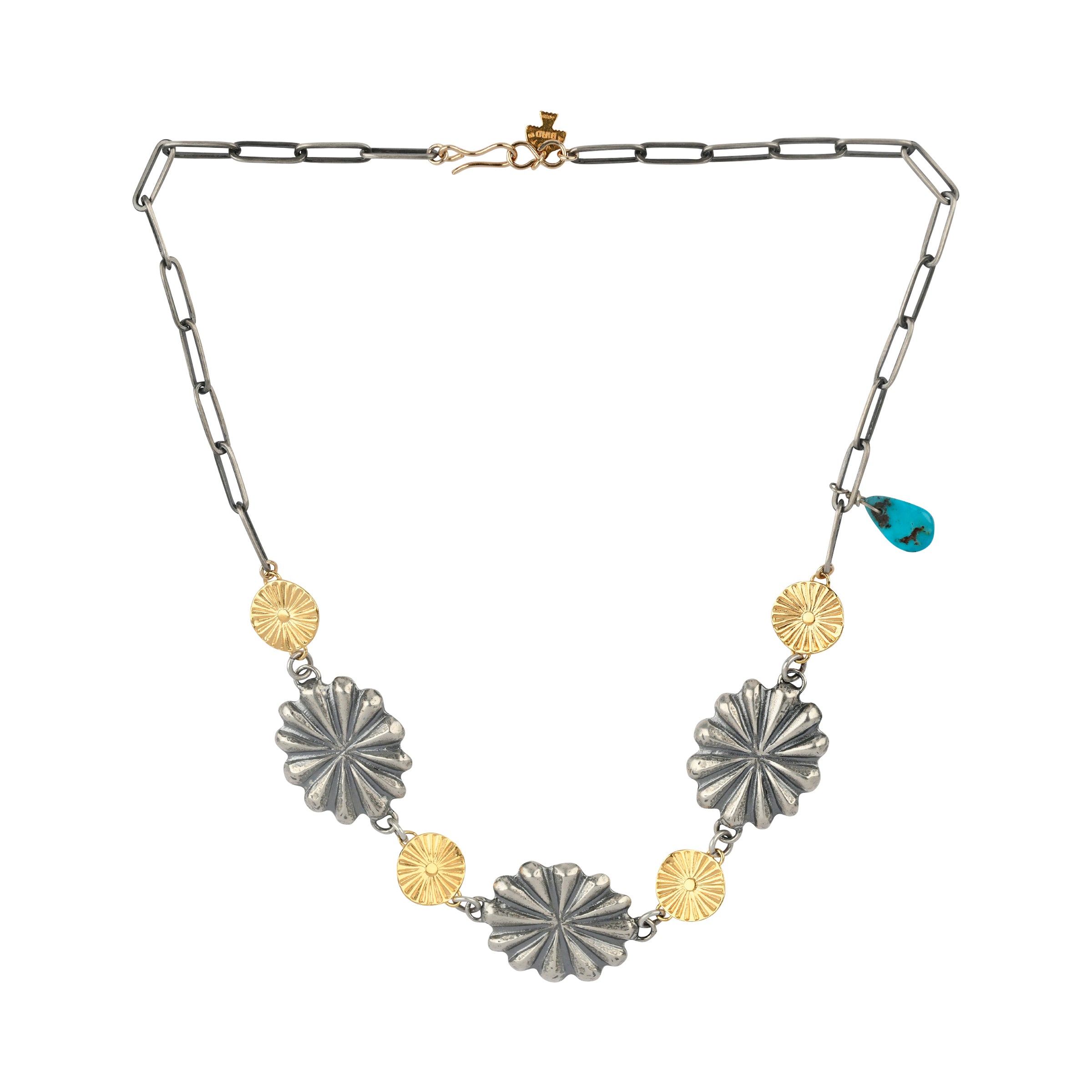 This necklace features a light, skinny chain with small, gold plated sunburst conchos alternating with larger classic conchos, finished with a teardrop of Turquoise for just a pop of Southwest charm.