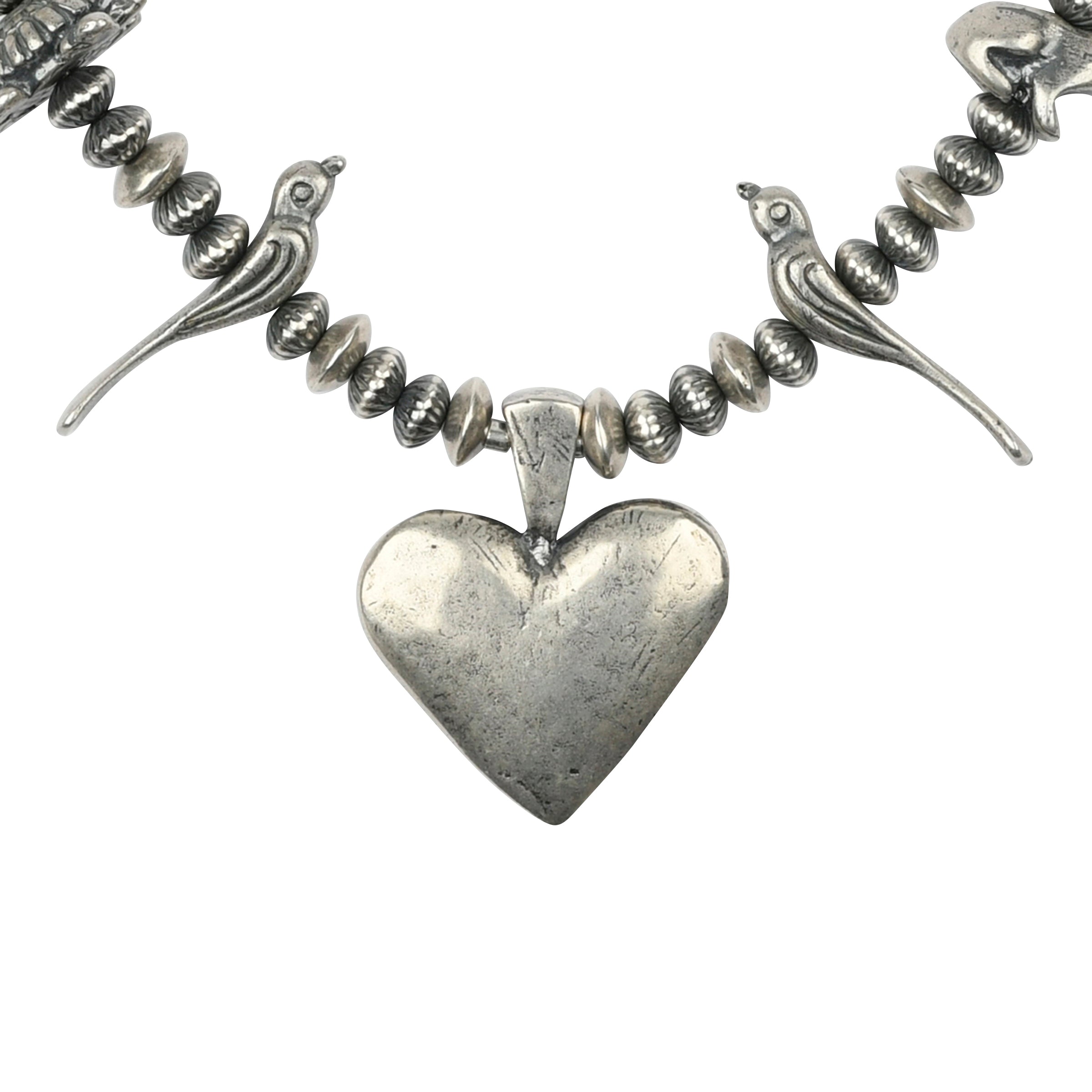 A Sterling Silver necklace featuring a Heart Pendant and animal totems - birds, turtles, bears, and frogs strung with vintage inspired beading