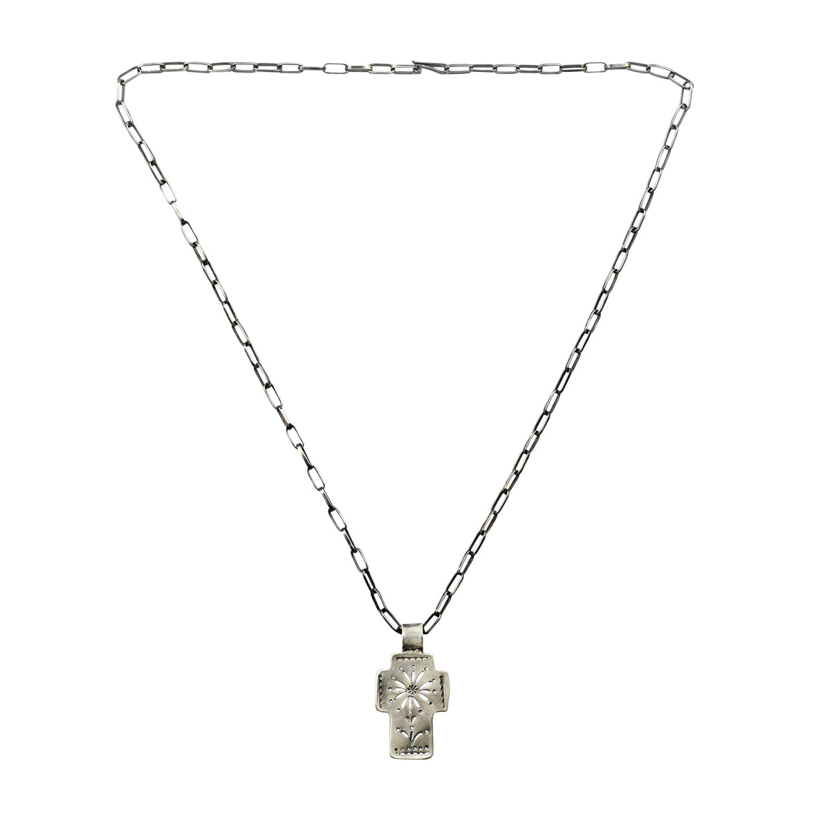 As seen in the Sundance Catalog, this piece is handcrafted from Sterling Silver and features a floral motif on a cross strung on chain.