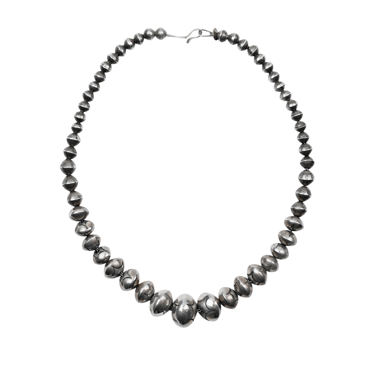 A vintage necklace strung with handmade, stamped Sterling Silver beads in a gradient pattern.