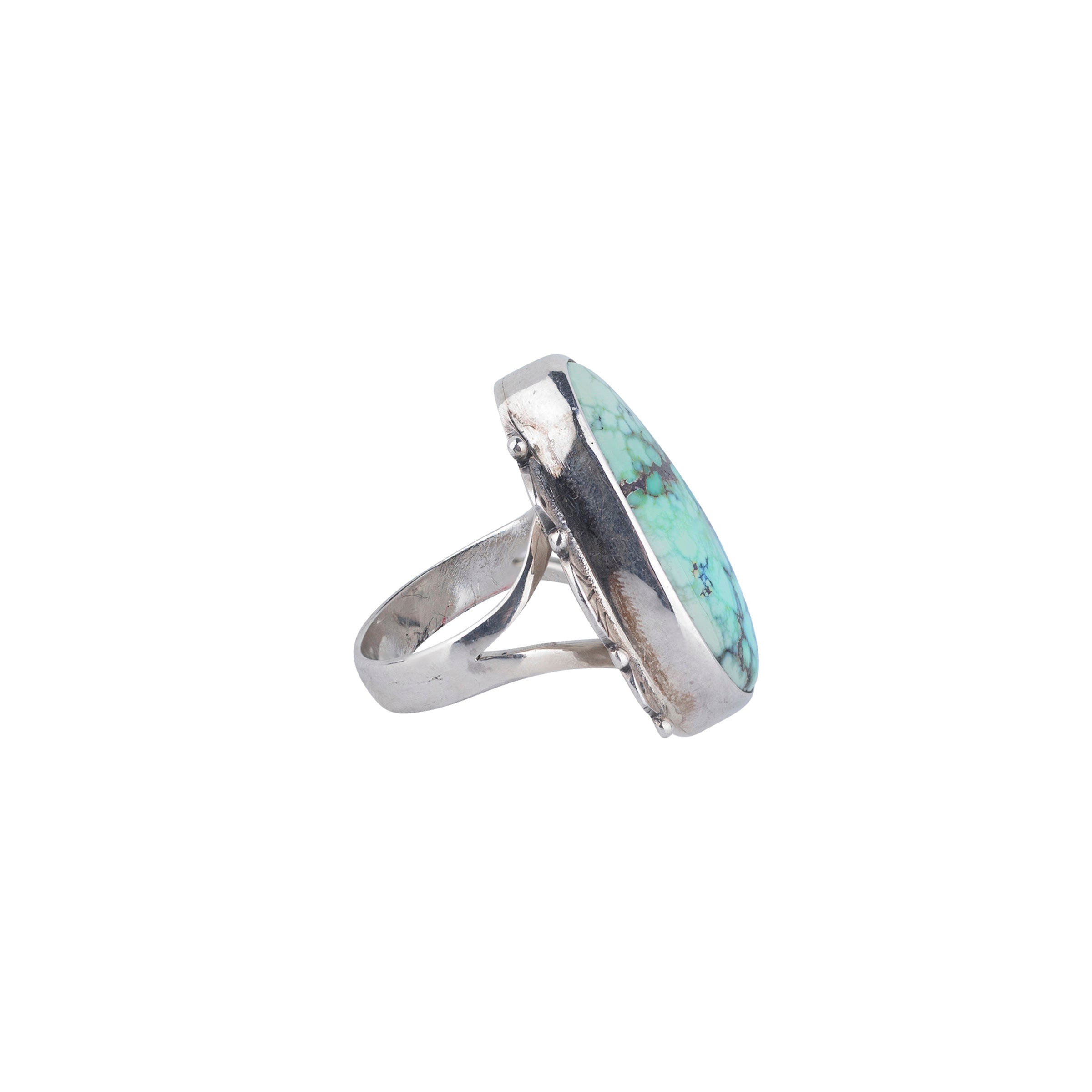 Sterling silver ring with scalloped detailing and large varied matrix turquoise stone side view. 