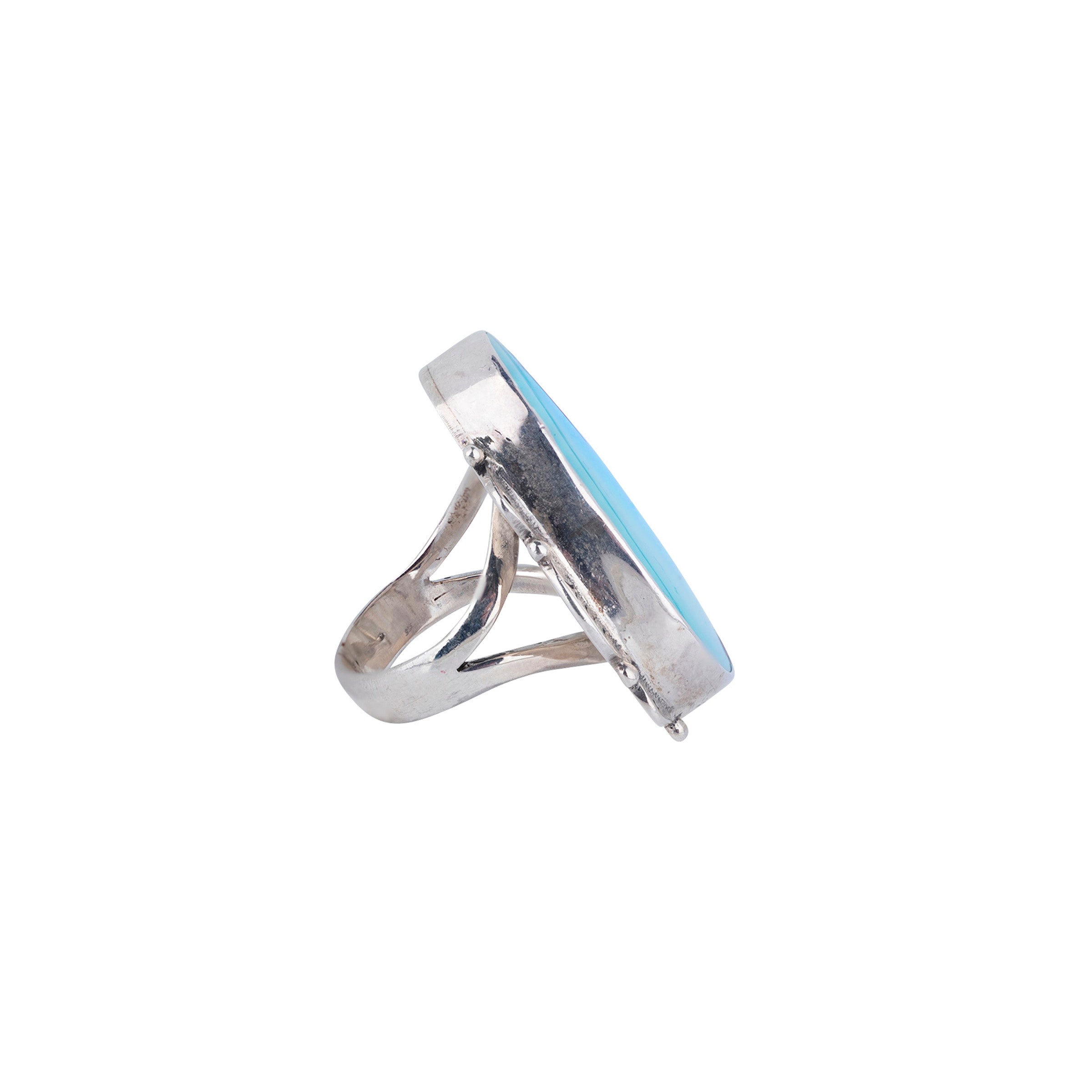Sterling silver ring with scalloped detailing and large clear blue turquoise stone side view.