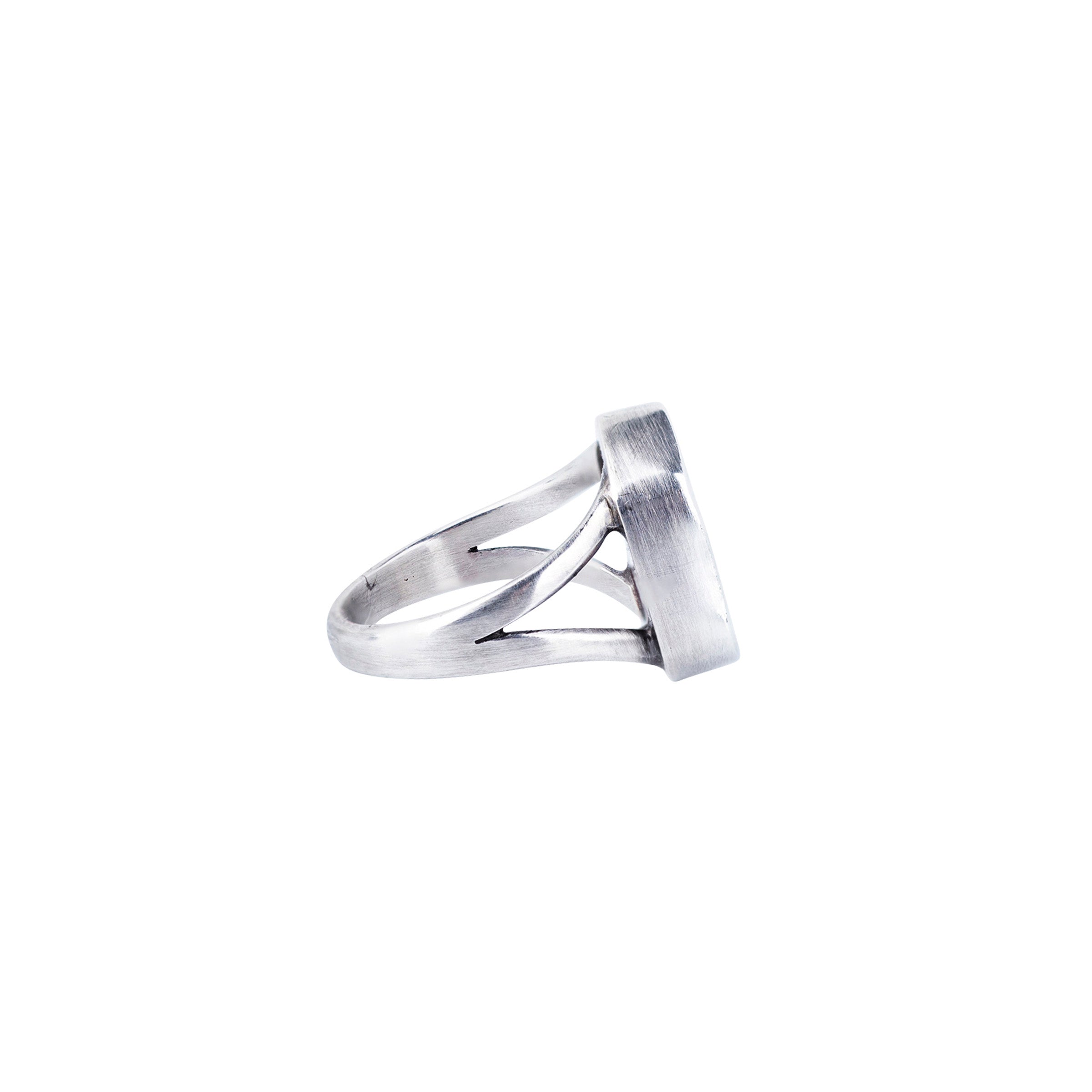Side view sterling silver wrapping around geometric stone ring with two shanks. 