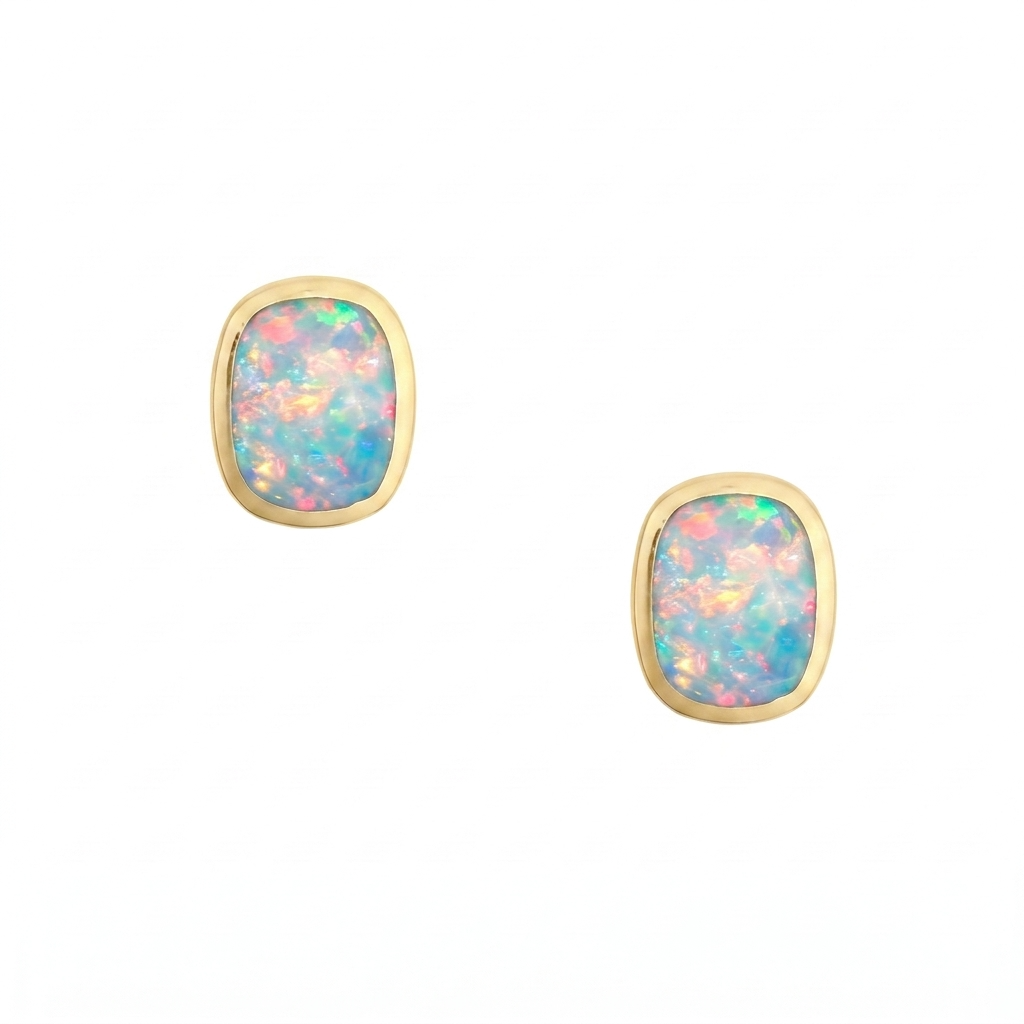 A pair of sterling silver and gold plated stud earrings with rounded rectangular white opal cabochons and comfort earring backs.
