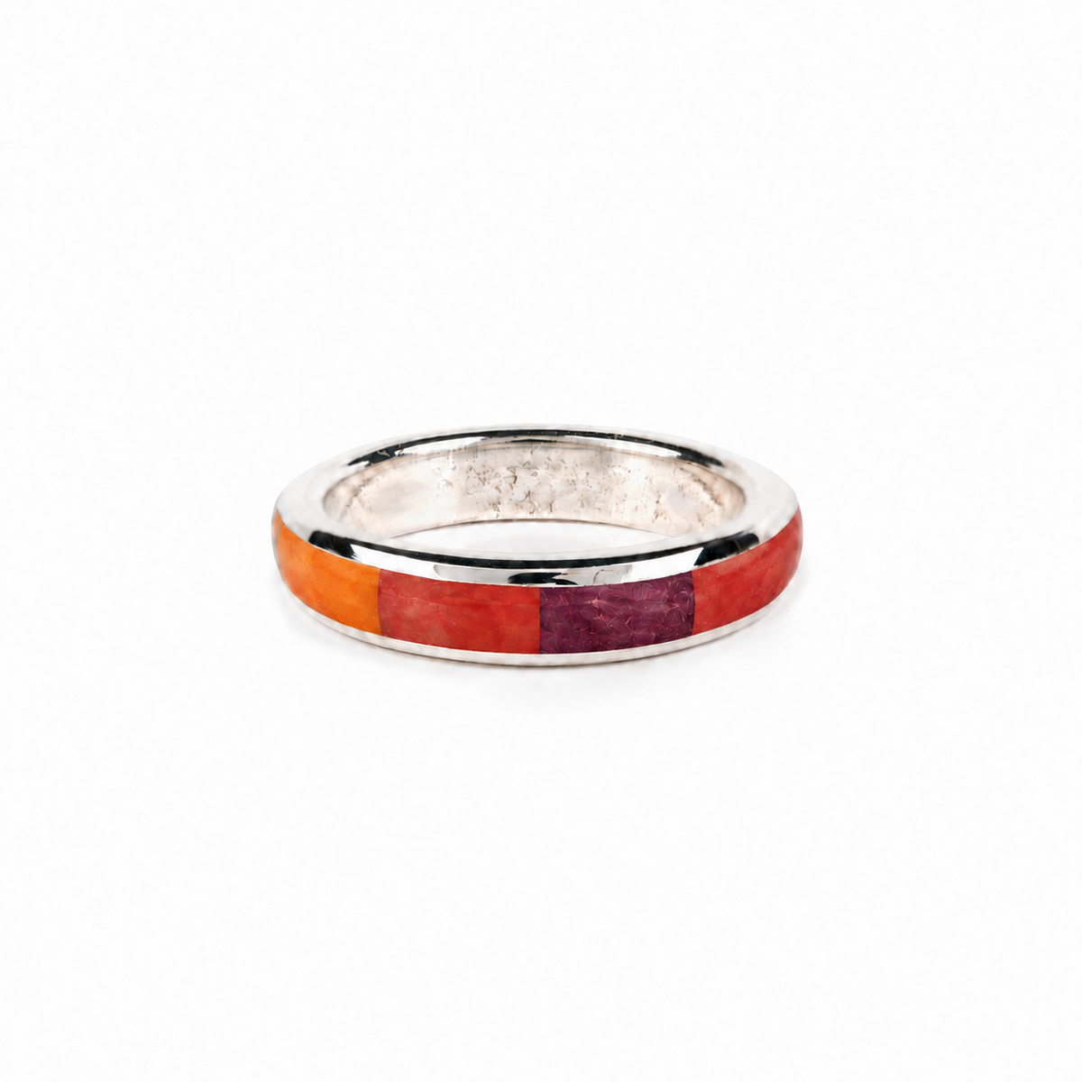 A sterling silver ring with a mix of spiny oyster shell inlay.