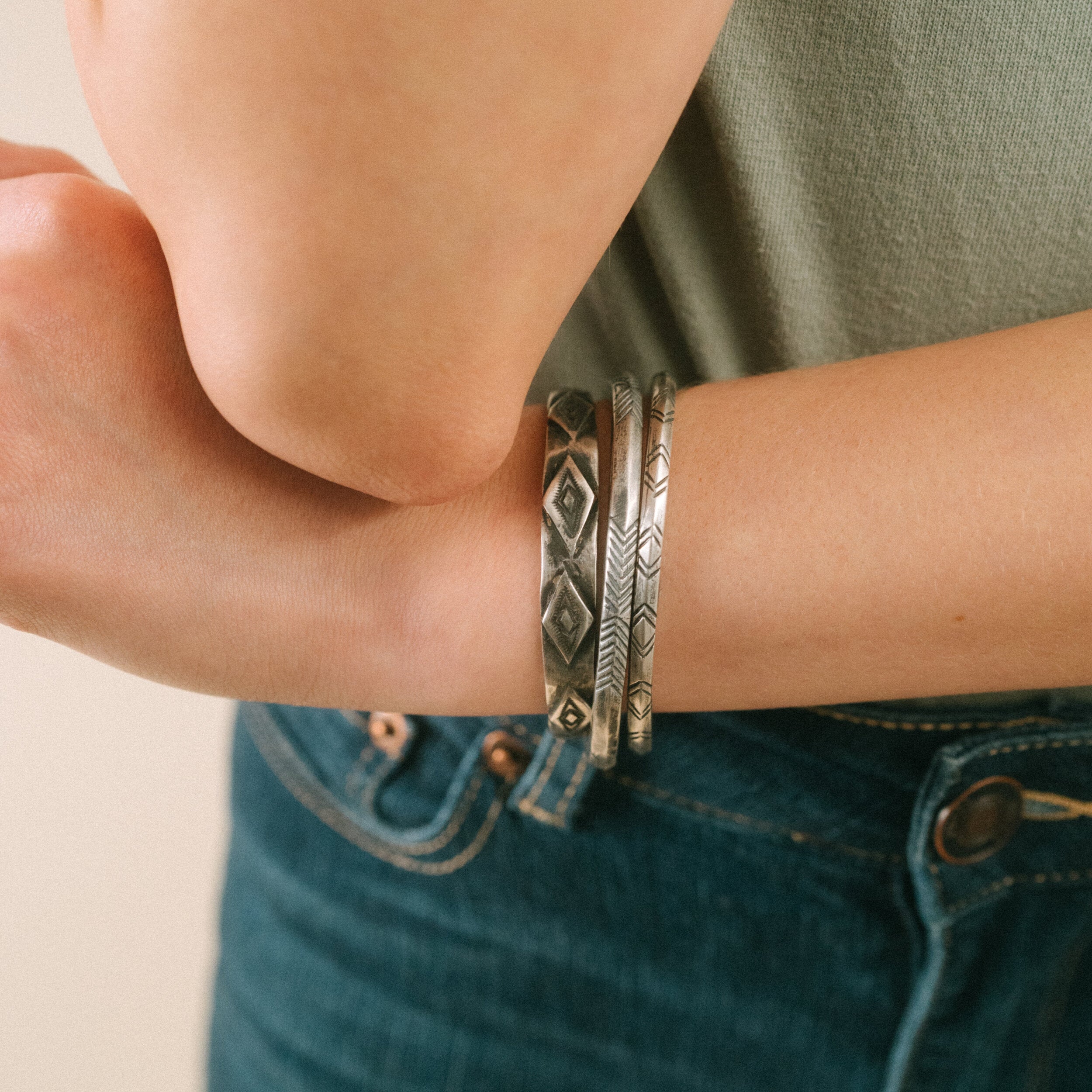 A sterling silver cuff bracelet from artisan Jock Favour with a symmetrical geometric stamped pattern. Made in USA.