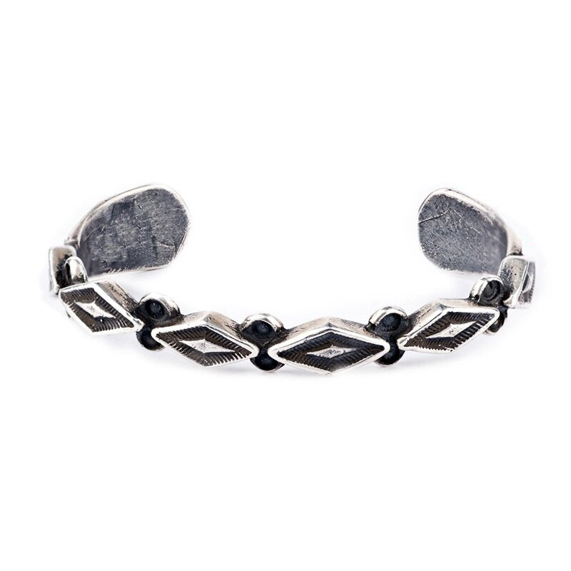 The Pyramids Cuff from artist Jock Favour is pure sterling silver. Highlighted by a unique diamond design and precise stamp work. 