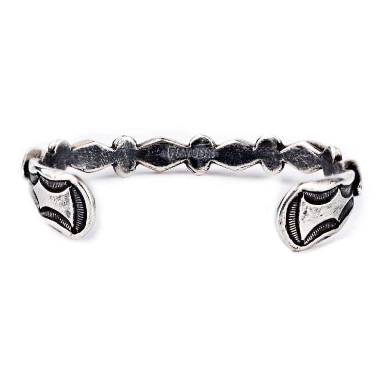 The Pyramids Cuff from artist Jock Favour is pure sterling silver. Highlighted by a unique diamond design and precise stamp work. 