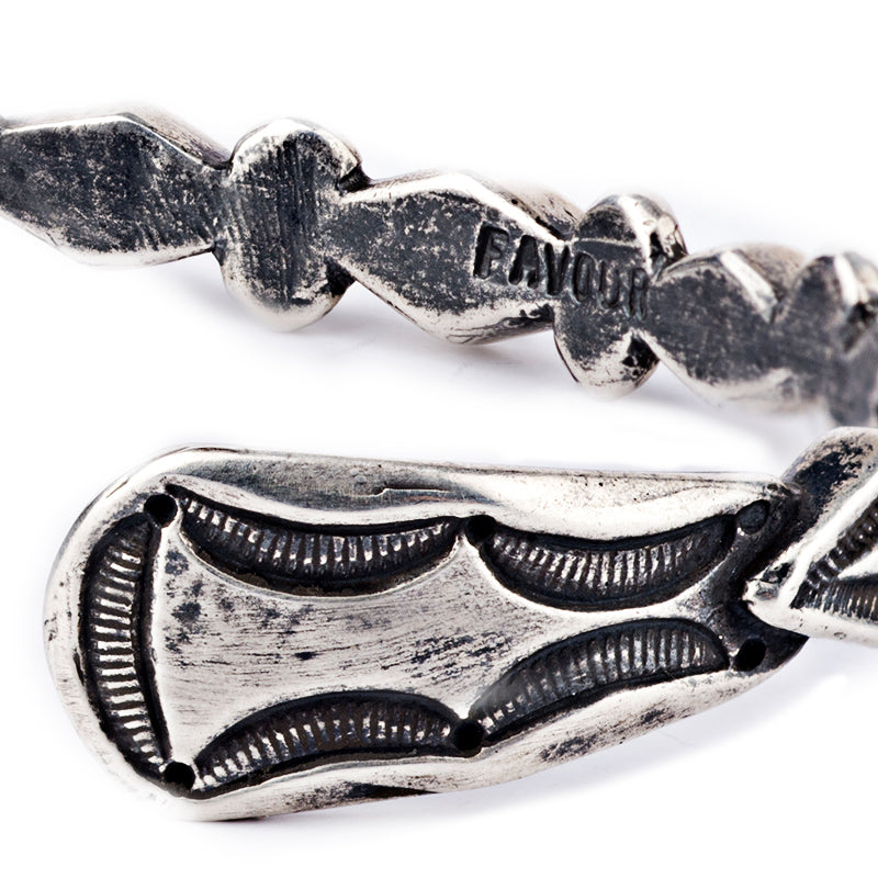 The Pyramids Cuff from artist Jock Favour is pure sterling silver. Highlighted by a unique diamond design and precise stamp work. 