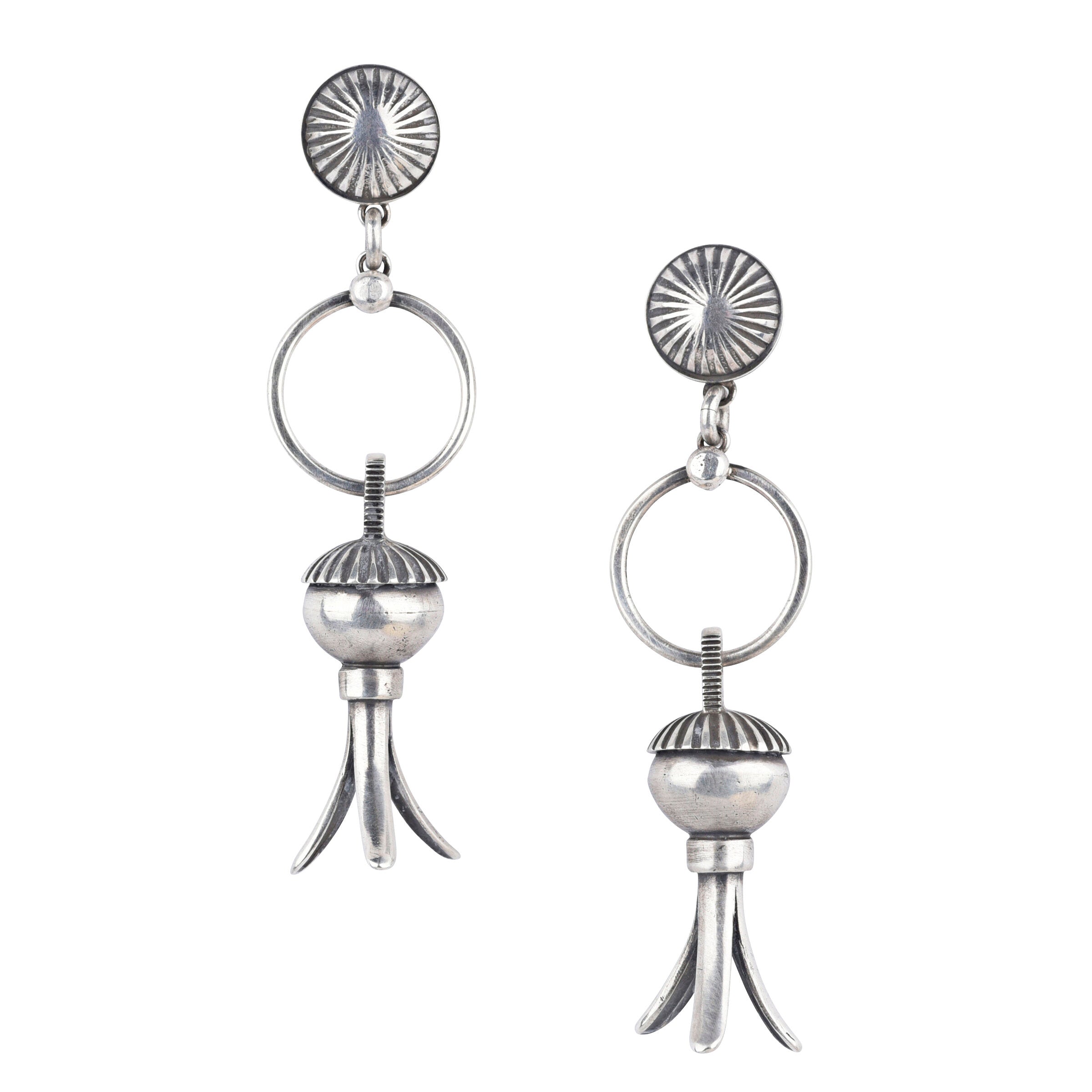 The Madrid earrings from Dennis Hogan are pure Southwest style. Featuring Sterling Silver and the iconic squash blossom with a bold concho post. These earrings will elevate any outfit.