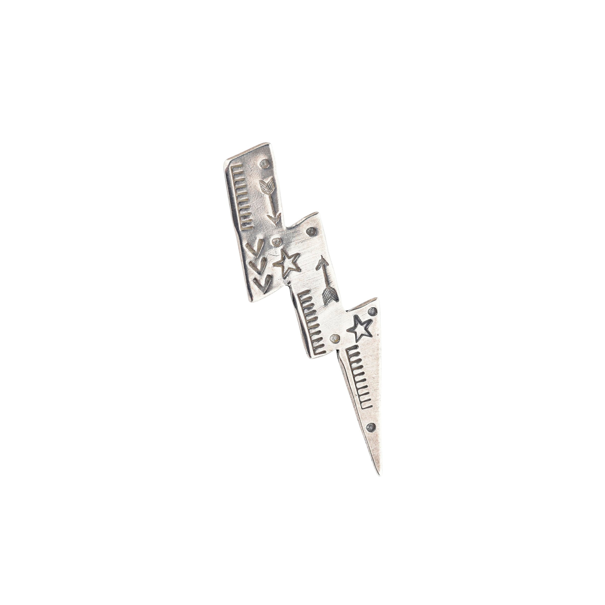 A stamped sterling silver lightning bolt pin from artist Joe Eby that is a perfect addition to any hat or jacket.