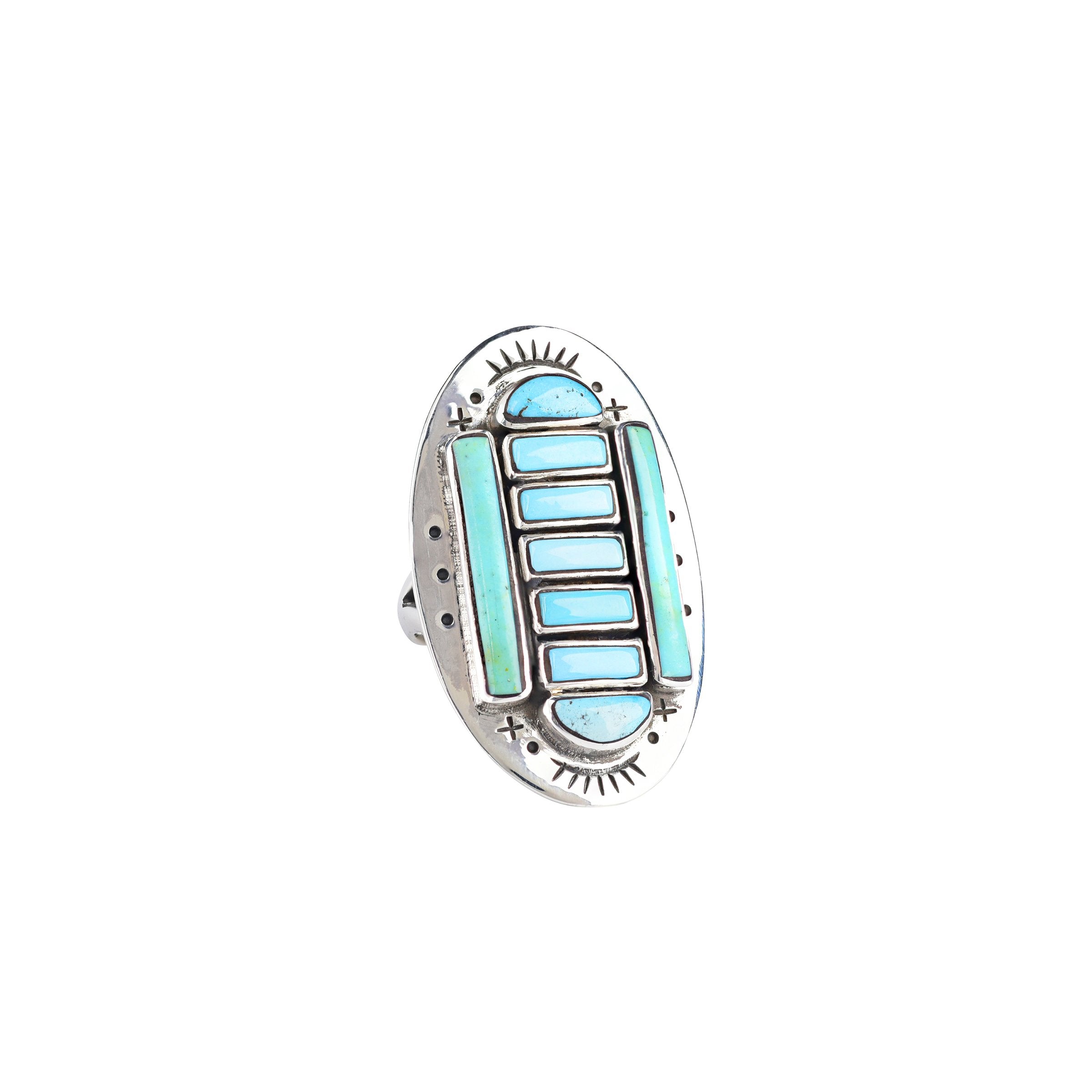 A sterling silver shield ring with blue and green turquoise. Symmetrical stamping on the silver shield adds a unique touch.