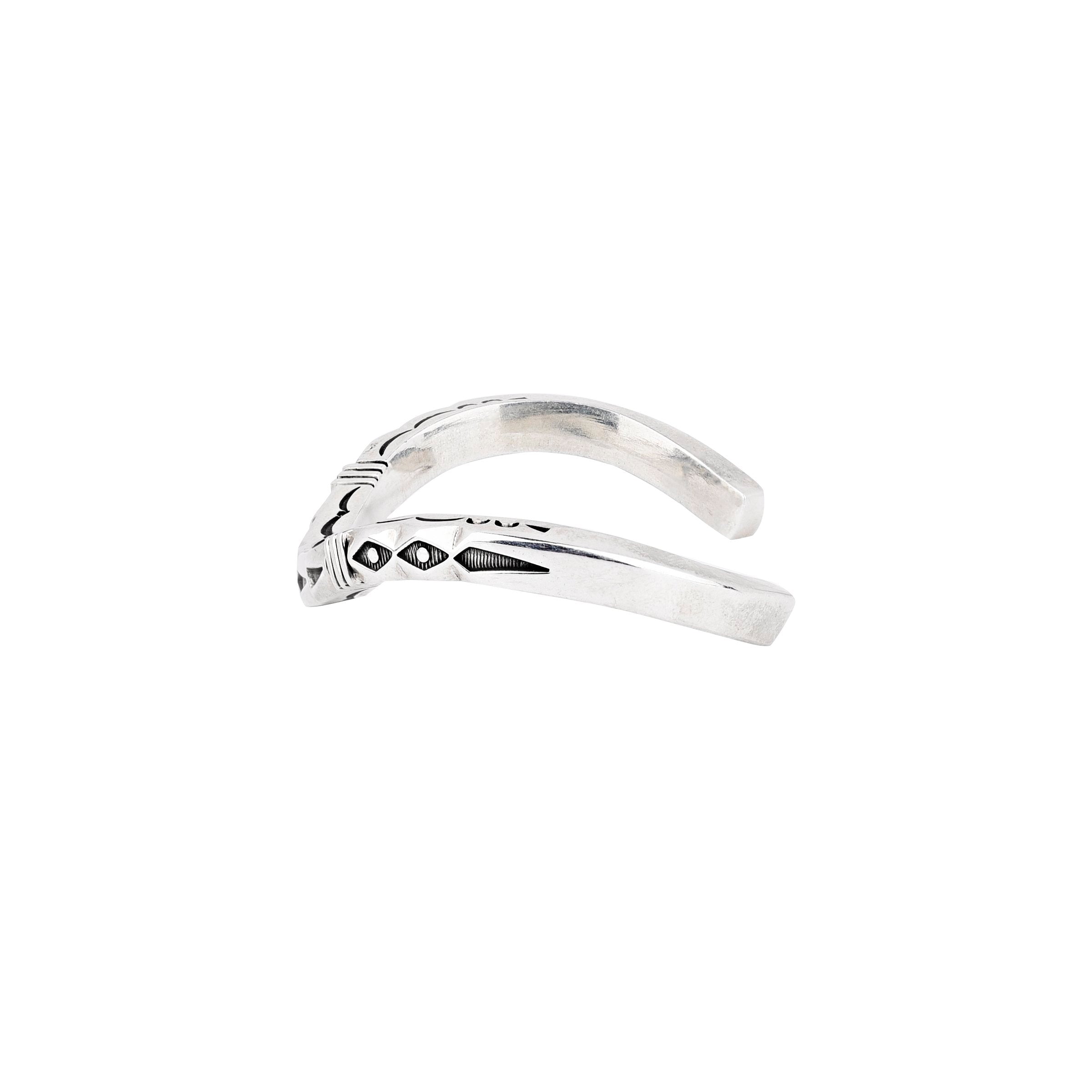Curved sterling silver cuff bracelet from artist Jennifer Curtis. Featuring intricate stamping and design.