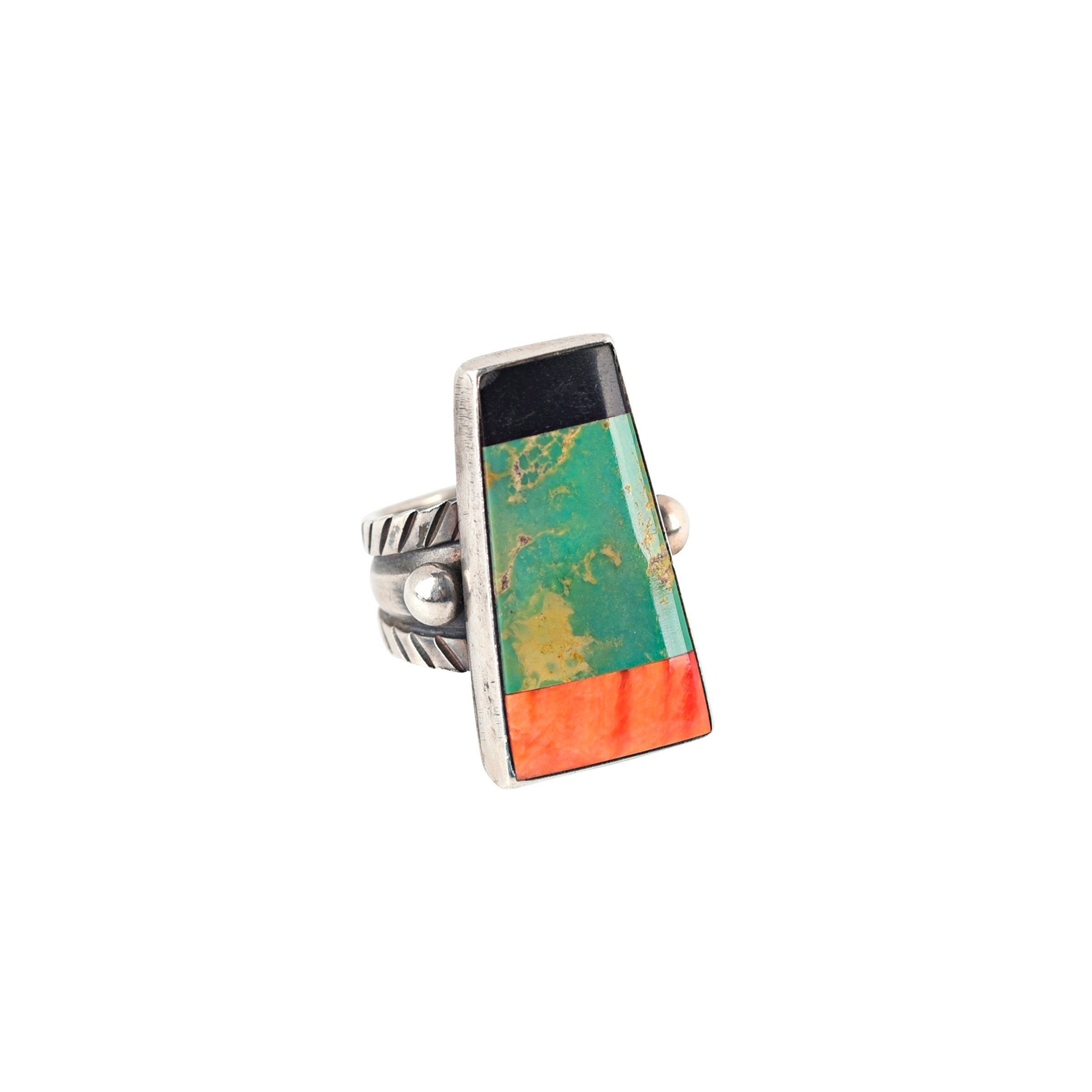 The Forest Floor Ring from artist Jessie Robbins features stamped ingot coin silver with green turquoise, orange spiny oyster shell, and onyx stone inlay. Made in USA.