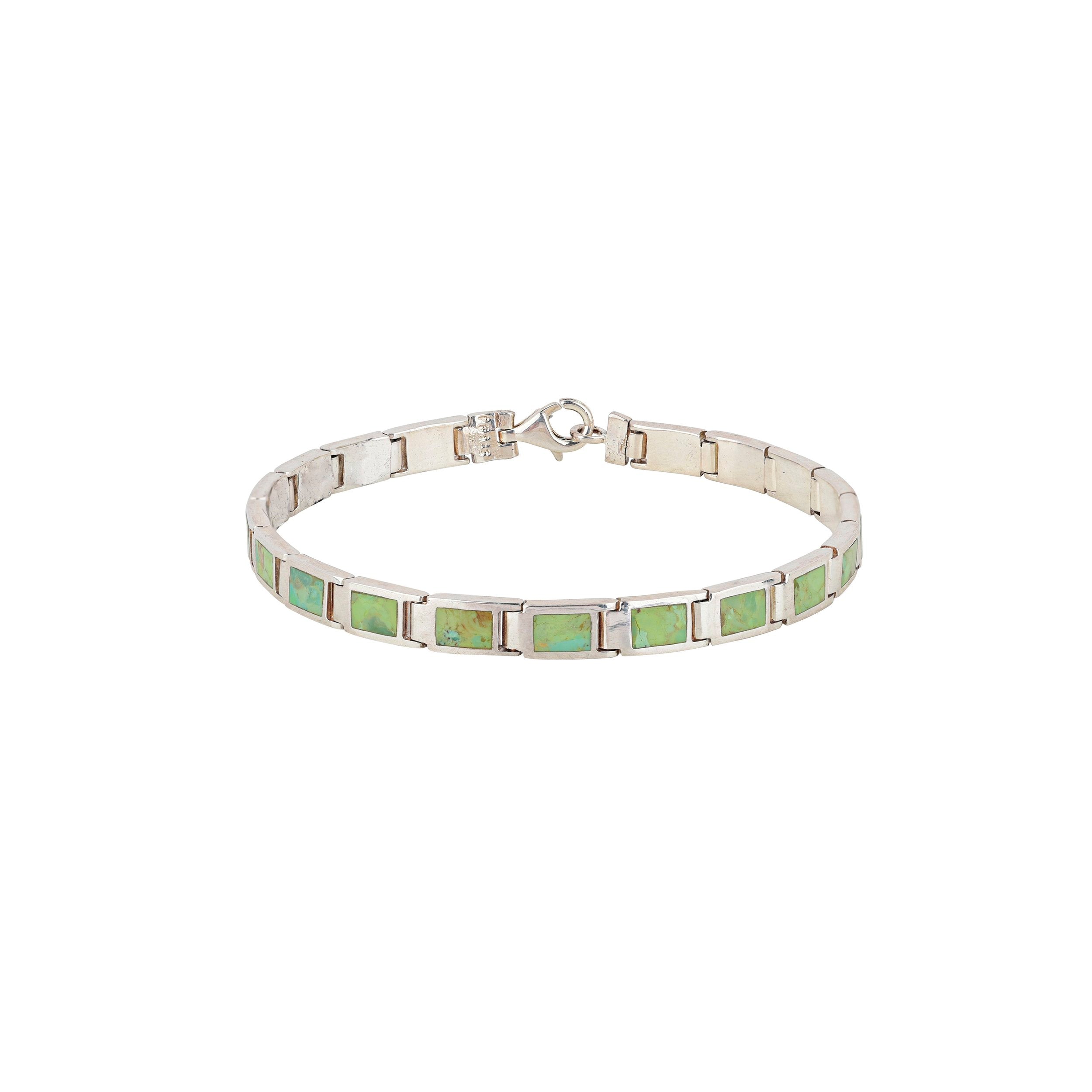 A silver bracelet with green and blue stone accents, featuring a clasp.
