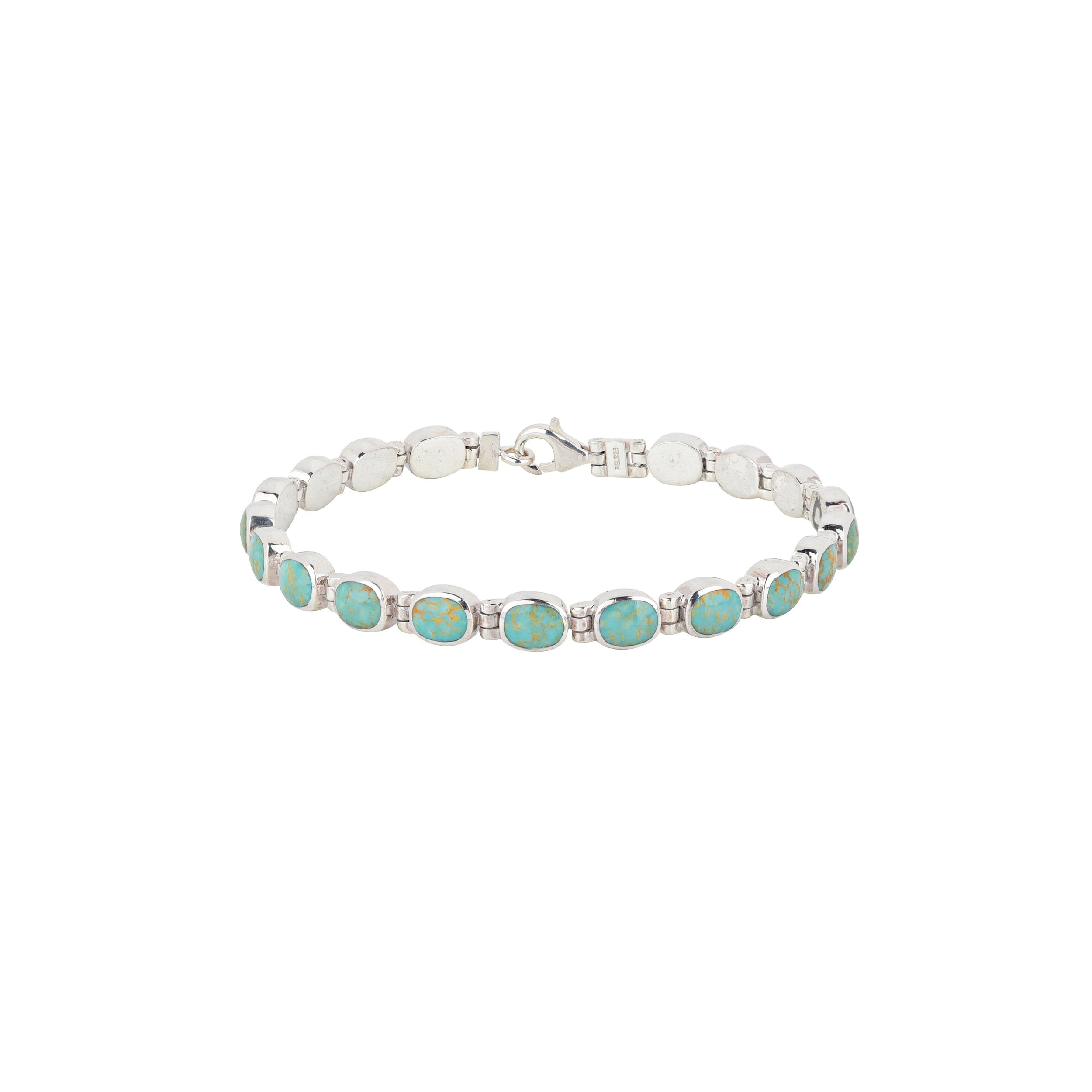 The Arroyo link bracelet from the Bird and Arrow collection features sterling silver and  green turquoise stones.